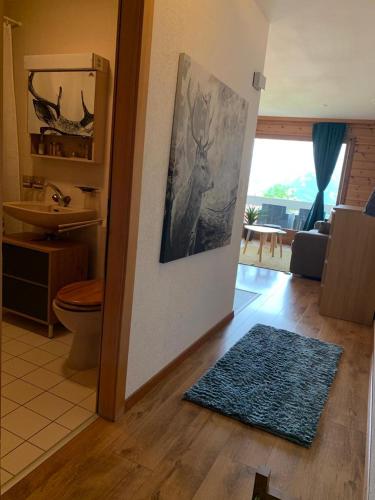 a bathroom with a painting of a deer on the wall at Studio Hauts-de-Nendaz G2 ski in-out in Nendaz
