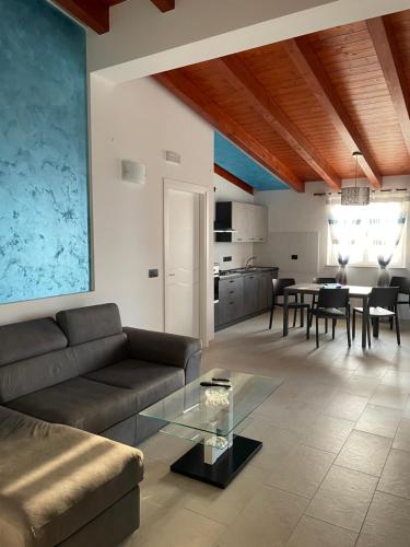 a living room with a couch and a table at Casa vacanze “ il Tramonto” in Milazzo
