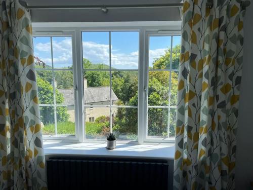 a window with a view of a house at The Haven at Halsons in Bridport
