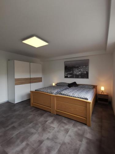 a bedroom with a large bed with two lights on it at Moderne Wohnung mit Terrasse und eigenem Zugang. in Remscheid