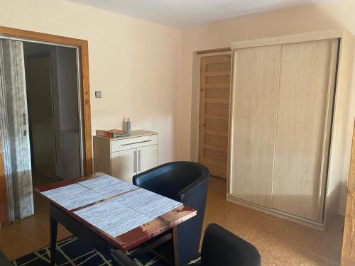 a room with a table and a chair and a door at Privat Šmídová Petra in Tábor
