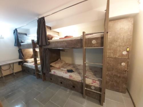 a room with two bunk beds in a room at Hostel VOYAGE in Batumi