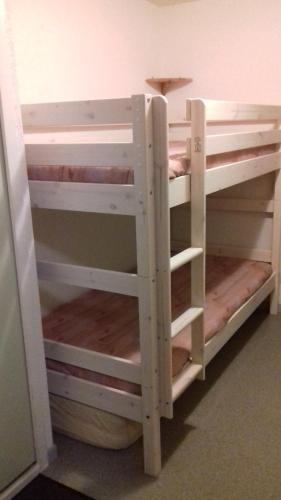 a set of wooden bunk beds in a room at Studio St Lary proche du centre, au calme avec vue montagne in Saint-Lary-Soulan