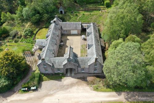 an aerial view of a large house with trees at Brylach Steading in Aberlour