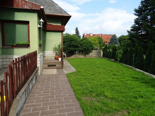 a dog sitting on the side of a house at CORSO Central Home, Keszthely in Keszthely