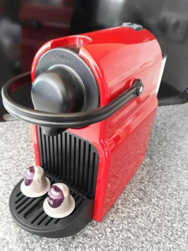 a red toaster sitting on top of a counter at Appartementhaus Grill in Strobl