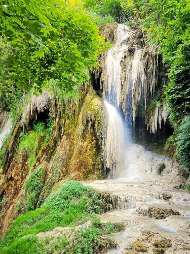 a waterfall on the side of a river at Apartament Iulia in Geoagiu Băi
