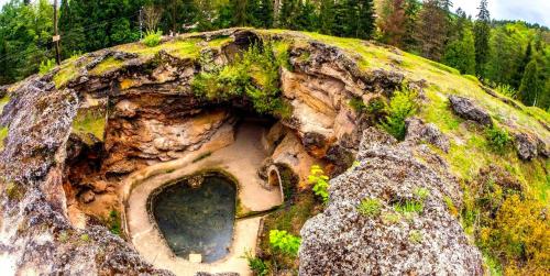 a large rock with a hole in the middle at Apartament Iulia in Geoagiu Băi