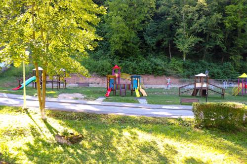 a park with a playground with a slide at Apartament Iulia in Geoagiu Băi