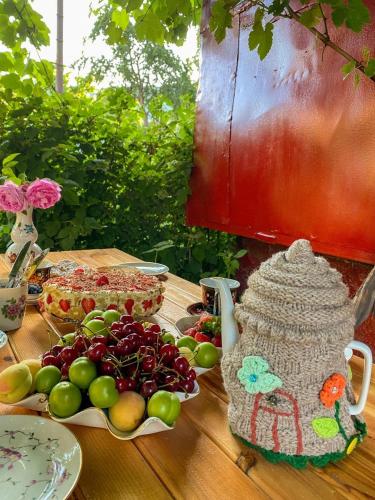 a table with a plate of fruit on a table at Aregak B&B and Tours in Goris