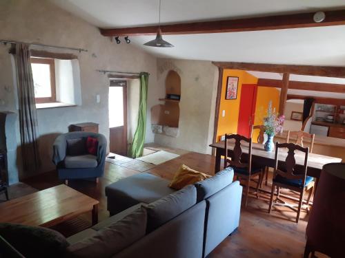 a living room with a couch and a table at Gite de Pascal et Virginie in Ponet-et-Saint-Auban