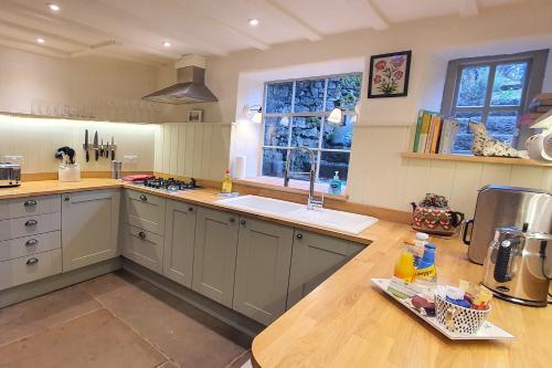 a kitchen with a sink and a counter top at Candle House, Winster, in the Peak District in Winster