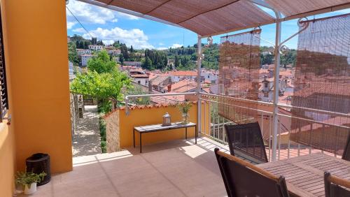 a balcony with a table and a view of a city at Holiday Home Amazing View in Piran