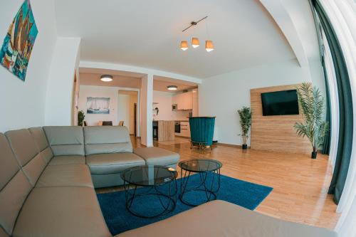 a living room with a couch and a table at Kaneo beach hotel Novalja in Novalja
