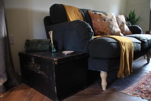 a living room with a couch and a table at Carpenters Rest, Wighton Near Wells Next The Sea in Wighton