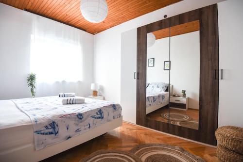 a bedroom with a mirror and a bed at Villa Adriatica in Marusici 