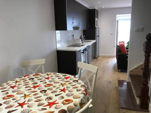 a kitchen with a table with shells on it at Apartamento vista al puerto de Finisterre II in Fisterra