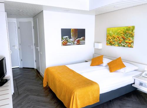 Ένα ή περισσότερα κρεβάτια σε δωμάτιο στο Fletcher Hotel-Restaurant Oud London