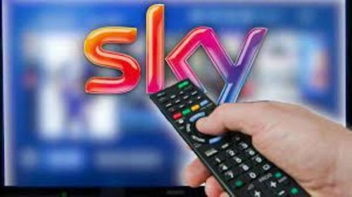 a person holding a remote control in front of a tv at Appartementhaus Grill in Strobl