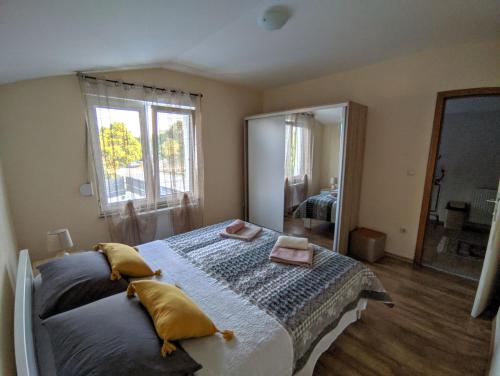 a bedroom with a large bed and a large mirror at Villa Longina in Ljubuški