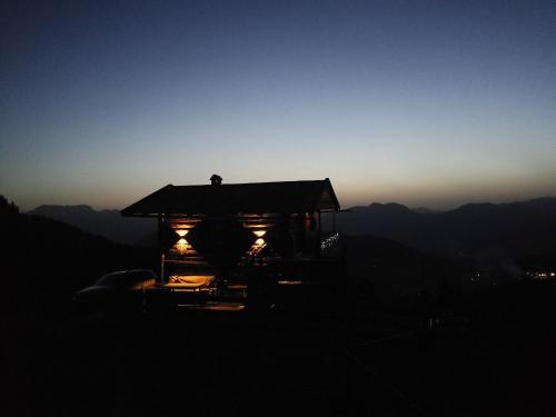 a small building with lights on top of a mountain at Almhütte Andrea in Wildschönau