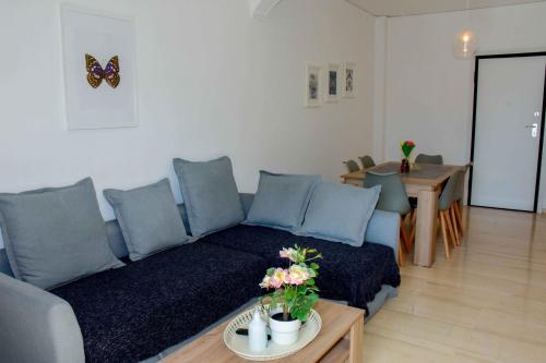 a living room with a couch and a table at Eclectic Apartment with Stunning Seaview in Porto Rafti