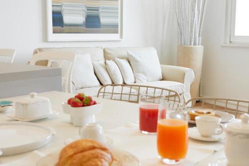 a coffee table with breakfast foods and a couch at Maison del Bassotto in Numana