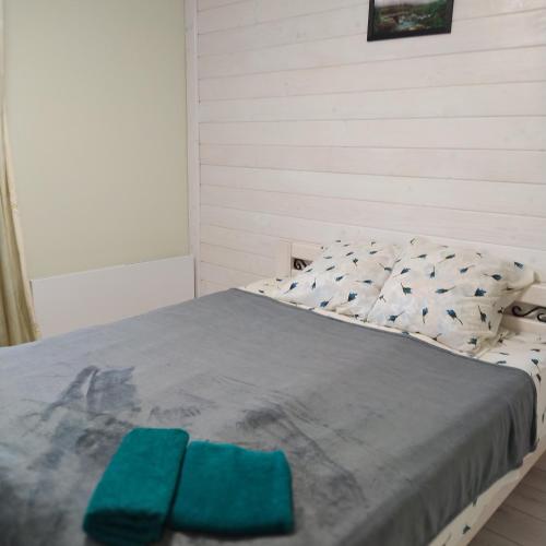 a bedroom with a bed with blue towels on it at Good House in Slavske