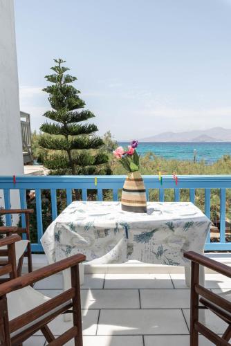 a table with a vase on top of it on a balcony at Castello studios in Agia Anna Naxos