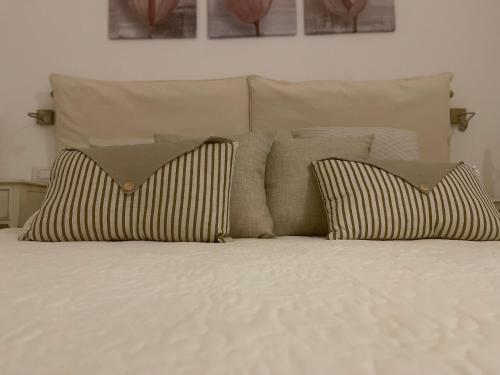a bed with two pillows on top of it at Le Dimore del Portico in Fasano
