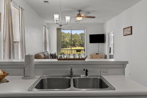 a kitchen counter with a sink and a window at Tee Time in Sunset Beach