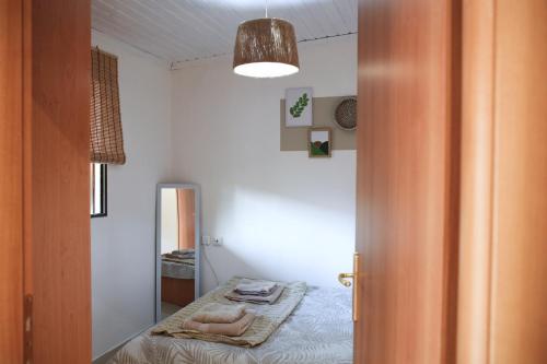 a bedroom with a bed with towels on it at LAXD Summer House by Homebrain in Makri