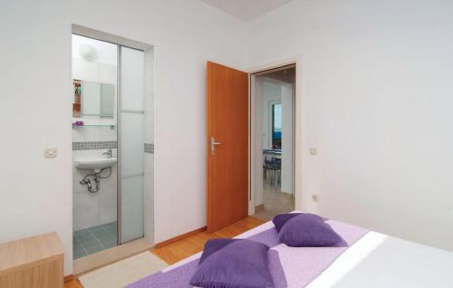 a bedroom with a bed and a bathroom with a sink at Holiday Home Tanja in Sutivan