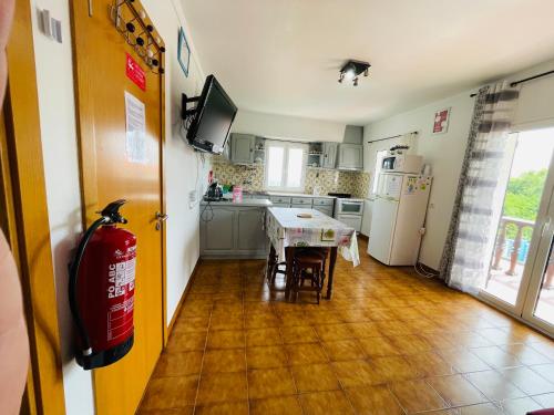 a kitchen with a table and chairs and a refrigerator at Fatima Belavista & Pool in Fátima