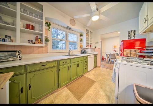 a kitchen with green cabinets and a red appliance at Modern Home • Family Friendly • Grill • Fireplace in Erie