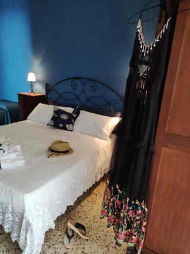 a bedroom with a bed with a black dress on it at Le DueLamie in Sessa Cilento