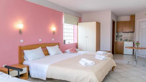 a bedroom with two beds with towels on them at Amversa's House in Potos