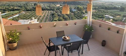 a table and chairs on a balcony with a view at Anna's House Theologos in Theologos