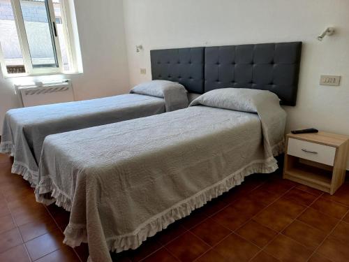 Postel nebo postele na pokoji v ubytování La Casa di Nonna Romina