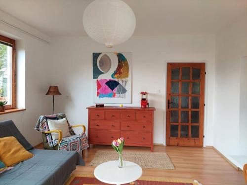a living room with a couch and a table at Erdőszéli Vendégház Zebegény in Zebegény
