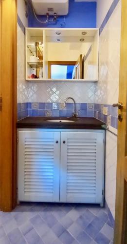 a kitchen with a sink and a mirror at Casa vacanze Lipari da Sergio spiaggia sotto casa in Lipari
