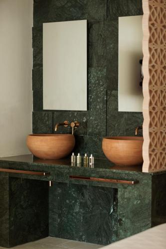 two sinks on a counter in a bathroom at Asty Mykonos Hotel & Spa - World of One Hotel Group in Mýkonos City