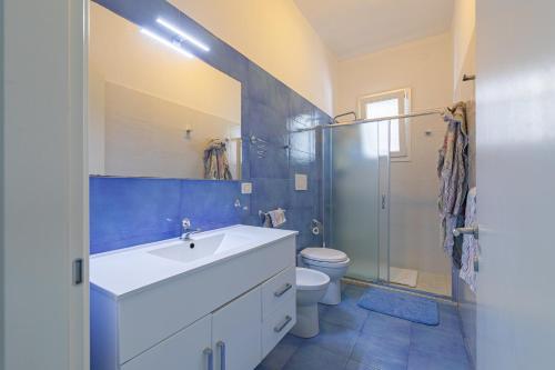 Un baño con lavabo, inodoro y ducha. en A Due Passi dal Mare, en Torre Lapillo