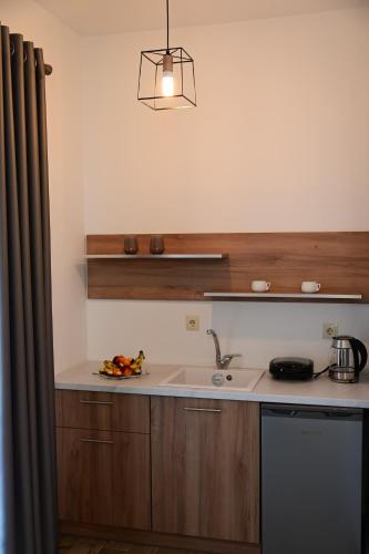 a kitchen with a sink and a counter top at BIG BLUE HOTEL in Amaliápoli
