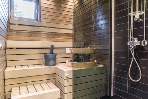 a bathroom with a shower and a sink at Lumi City Apartment in Levi