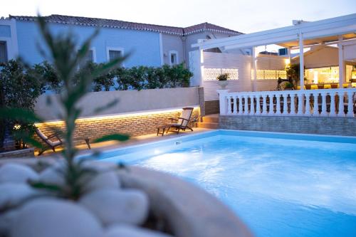 a swimming pool in the backyard of a house at Armata Boutique Hotel in Spetses