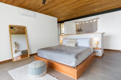 a bedroom with a large bed and a mirror at Casa Mirame in Carmen
