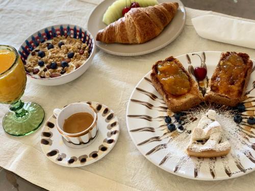 a table with plates of bread and a cup of coffee at HABITARE Lecce & Salento in Lecce