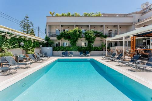 a swimming pool in front of a building at Telesilla Hotel in Kontokali