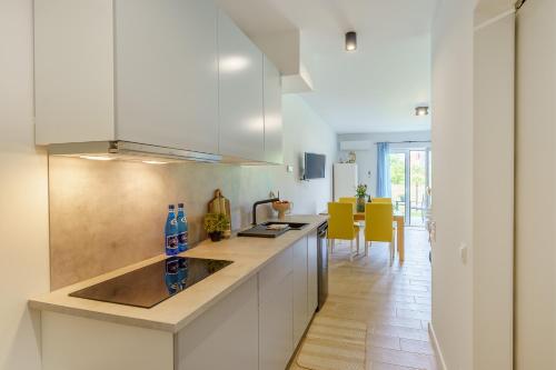 a kitchen with a sink and a counter top at Visit Baltic Apartament Morski Piasek in Sarbinowo